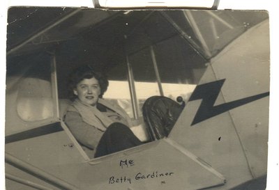 Elizabeth 'Bets' Gardiner in the rear seat of a Cub   at Stormville in 1943.  On the back, 'Learning to fly at Stormville Airport.'